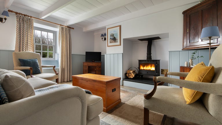 The sitting room with woodburner at Trescore, Cornwall